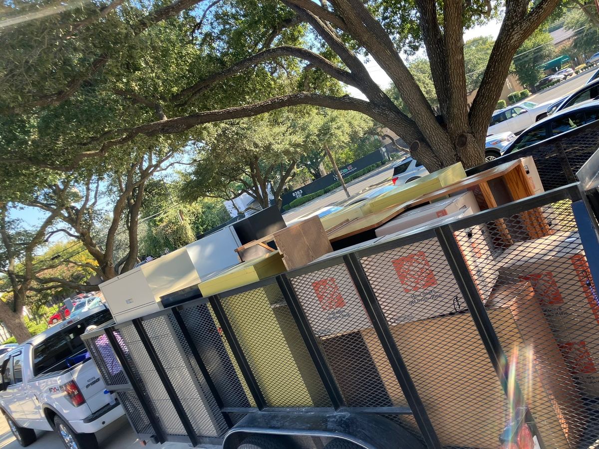 Office cabinets, desks and cardboard boxes stacked on a hauling trailer