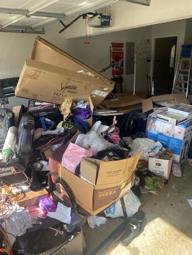 Two-car garage filled with boxes, bags and household items